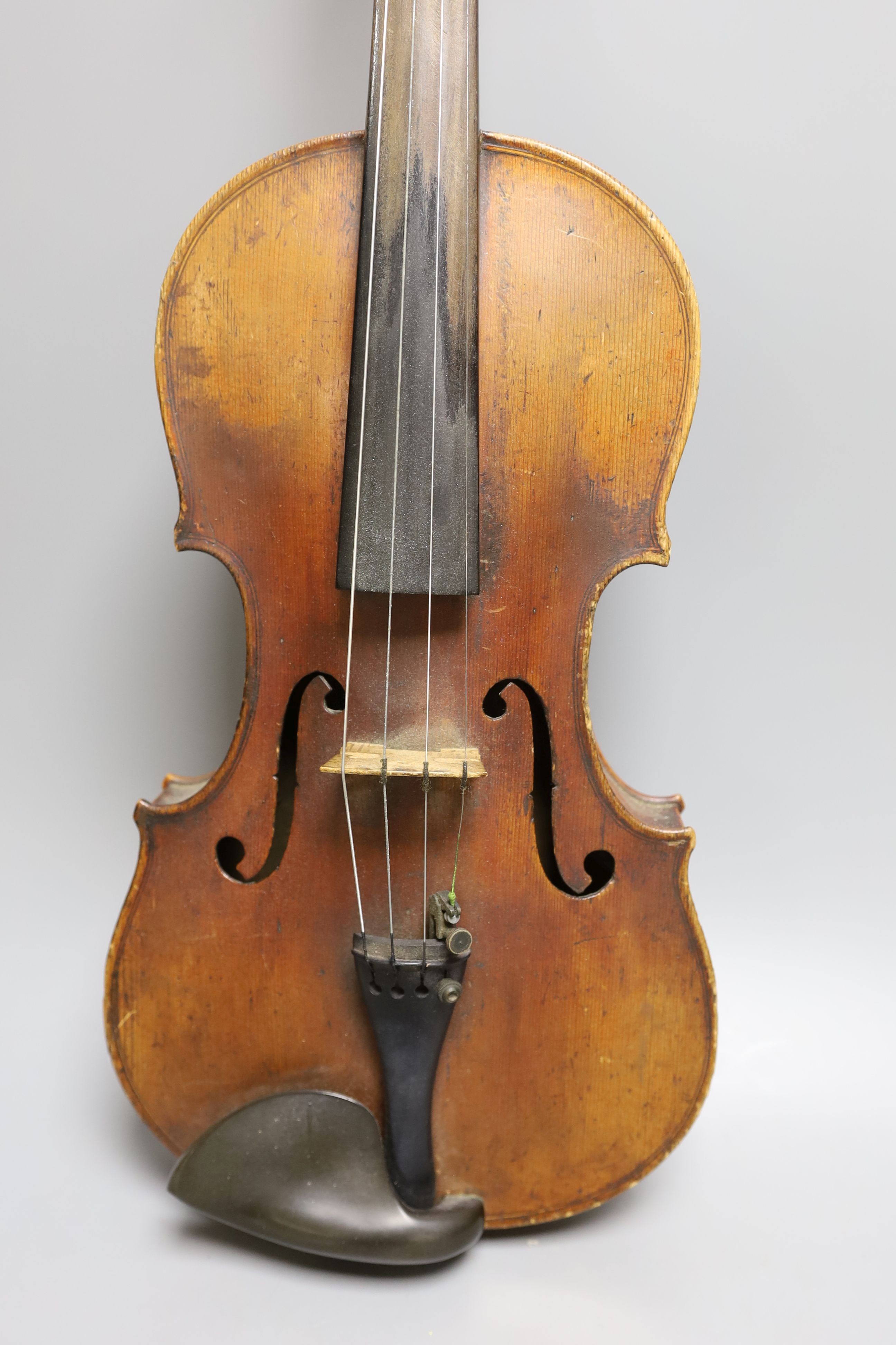 A 19th century violin with 14 inch 2 piece back, unlabelled, cased with silver mounted bow.